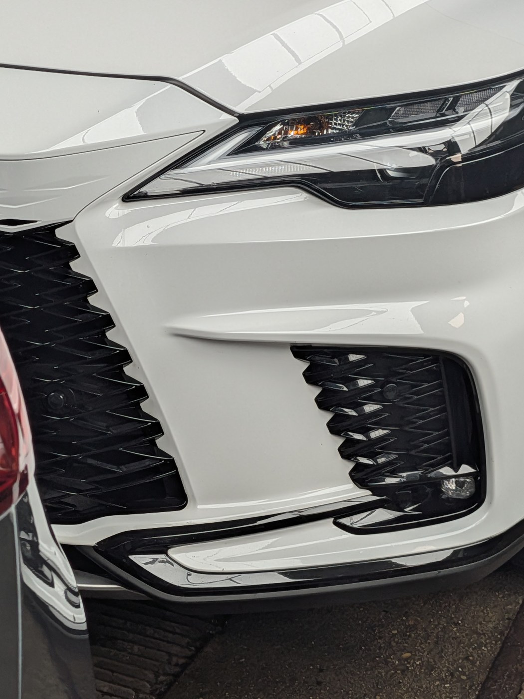 Lexus RX front headlight and grille detail, glossed
